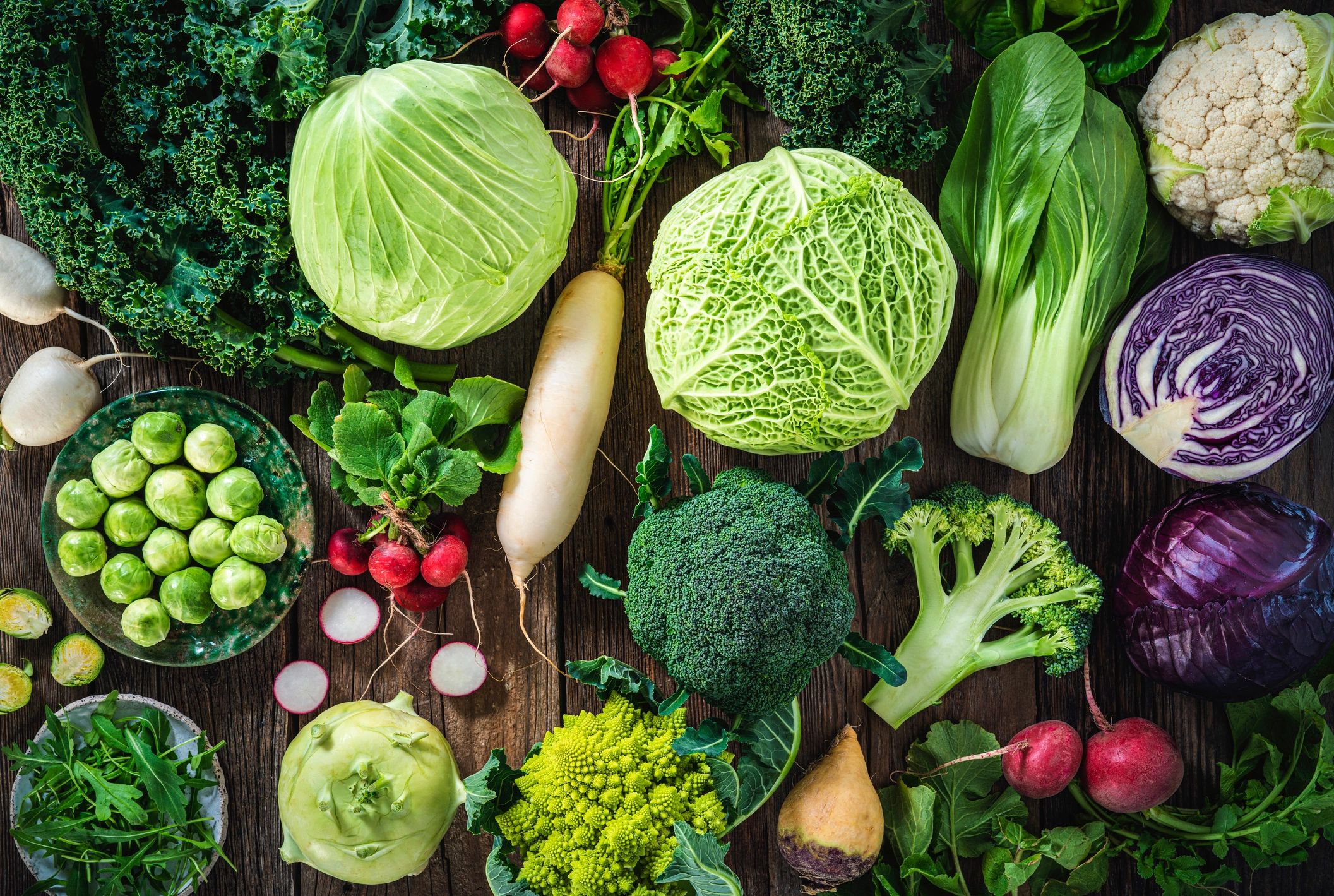 Assorted fresh vegetables on a rustic wooden surface
